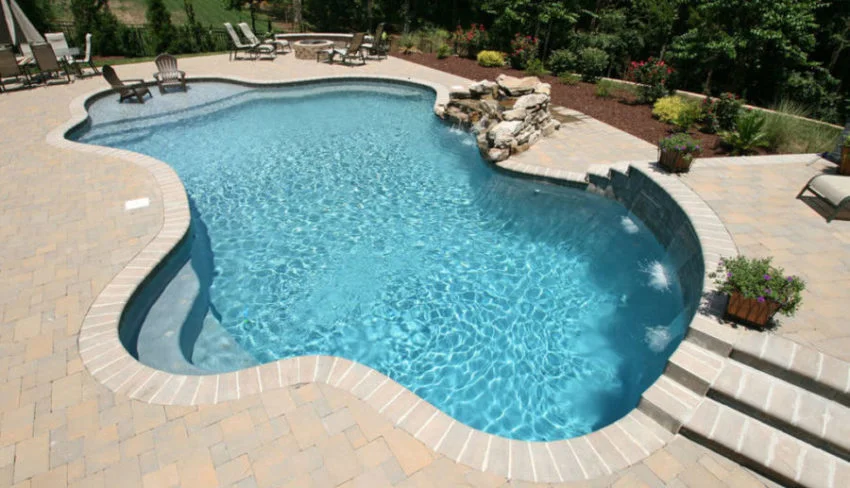 a large swimming pool with steps leading up to it.