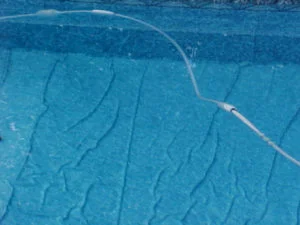 a pool with a hose attached to the side of it.