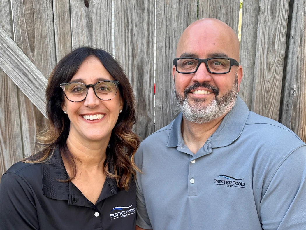 a man and woman smiling for a picture. - Prestige Pools - Prestige Pools a man and woman smiling for a picture.