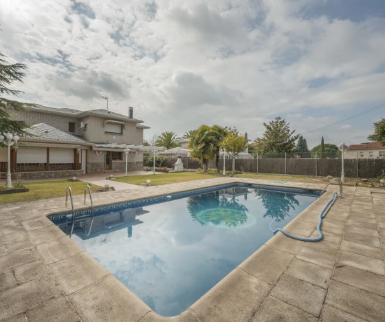 an empty pool in a backyard with a house in the background. - Prestige Pools - Prestige Pools an empty pool in a backyard with a house in the background.