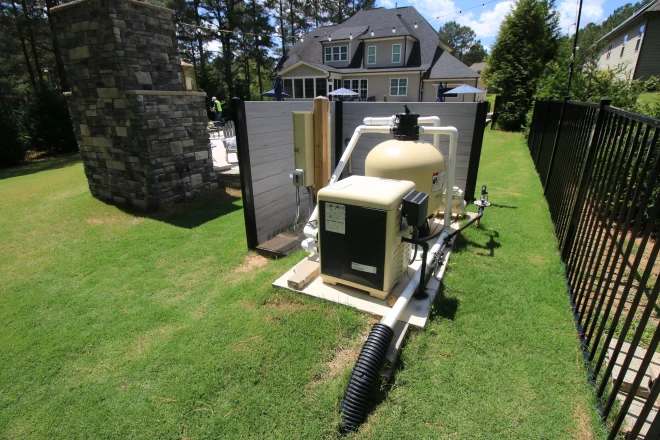 a pool pump in the backyard of a house. - Prestige Pools Various pool chemicals and cleaning equipment