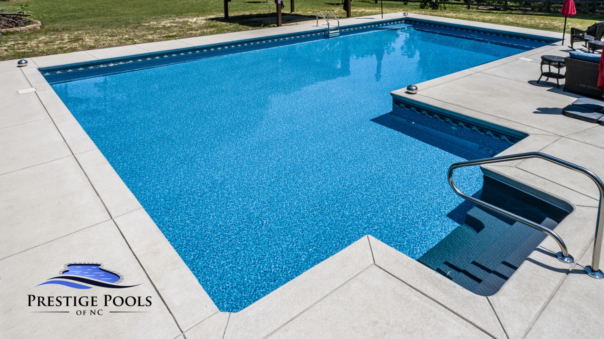 a swimming pool in a backyard with a deck.