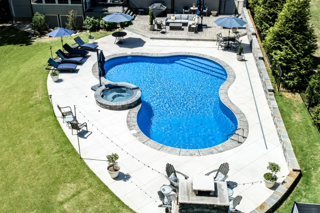 An aerial view of a swimming pool in a backyard. - Prestige Pools An aerial view of a swimming pool in a backyard.